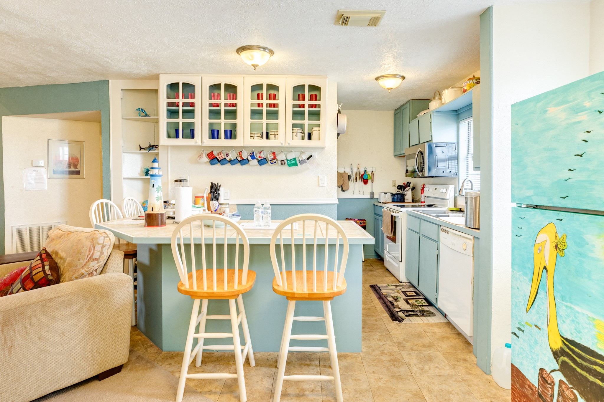 211 Pompano Lane Surfside Beach, TX 77541 - Photo 23 of 44 a view of a dining room with furniture and chandelier