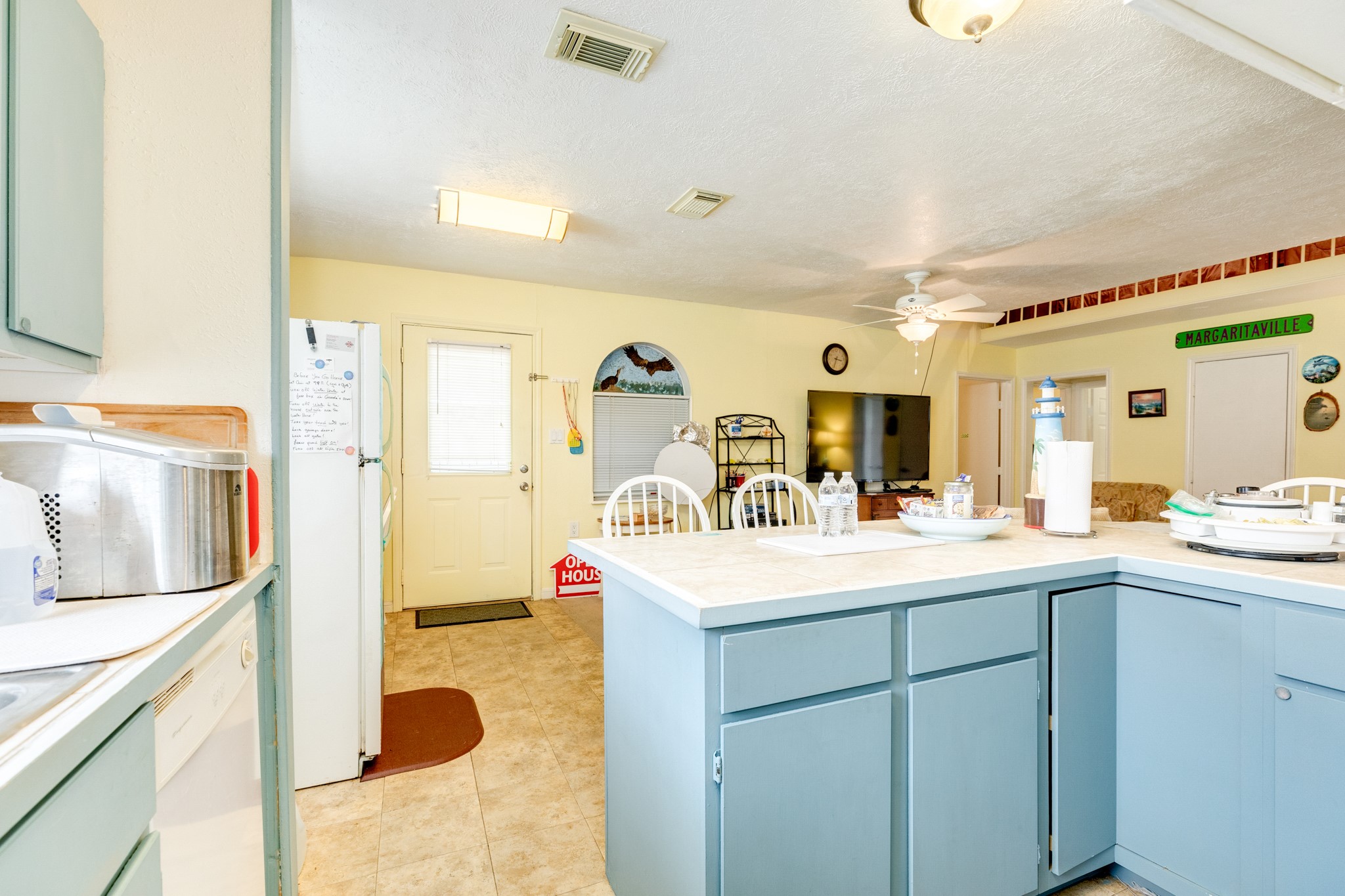 211 Pompano Lane Surfside Beach, TX 77541 - Photo 25 of 44 a kitchen with a sink and a refrigerator