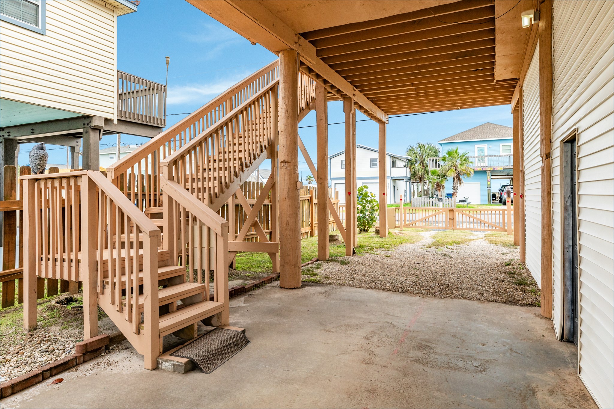 211 Pompano Lane Surfside Beach, TX 77541 - Photo 9 of 44 a view of staircase with wooden floor and fence