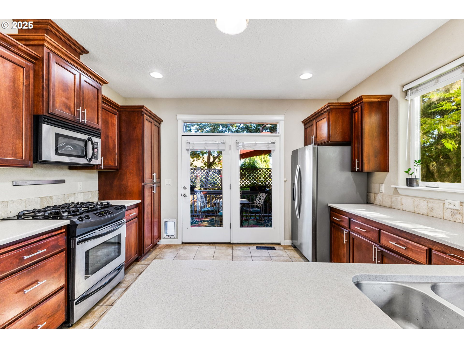 610 Northwest Hillcrest Drive Dallas, OR 97338 - Photo 11 of 32 a kitchen with stainless steel appliances granite countertop a refrigerator a stove top oven a sink and dishwasher