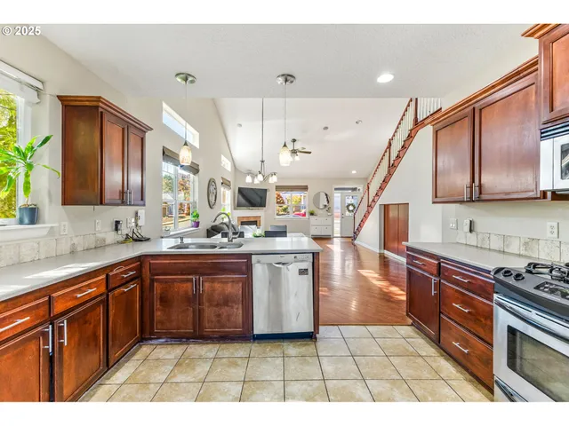 a open kitchen with stainless steel appliances granite countertop a sink and cabinets