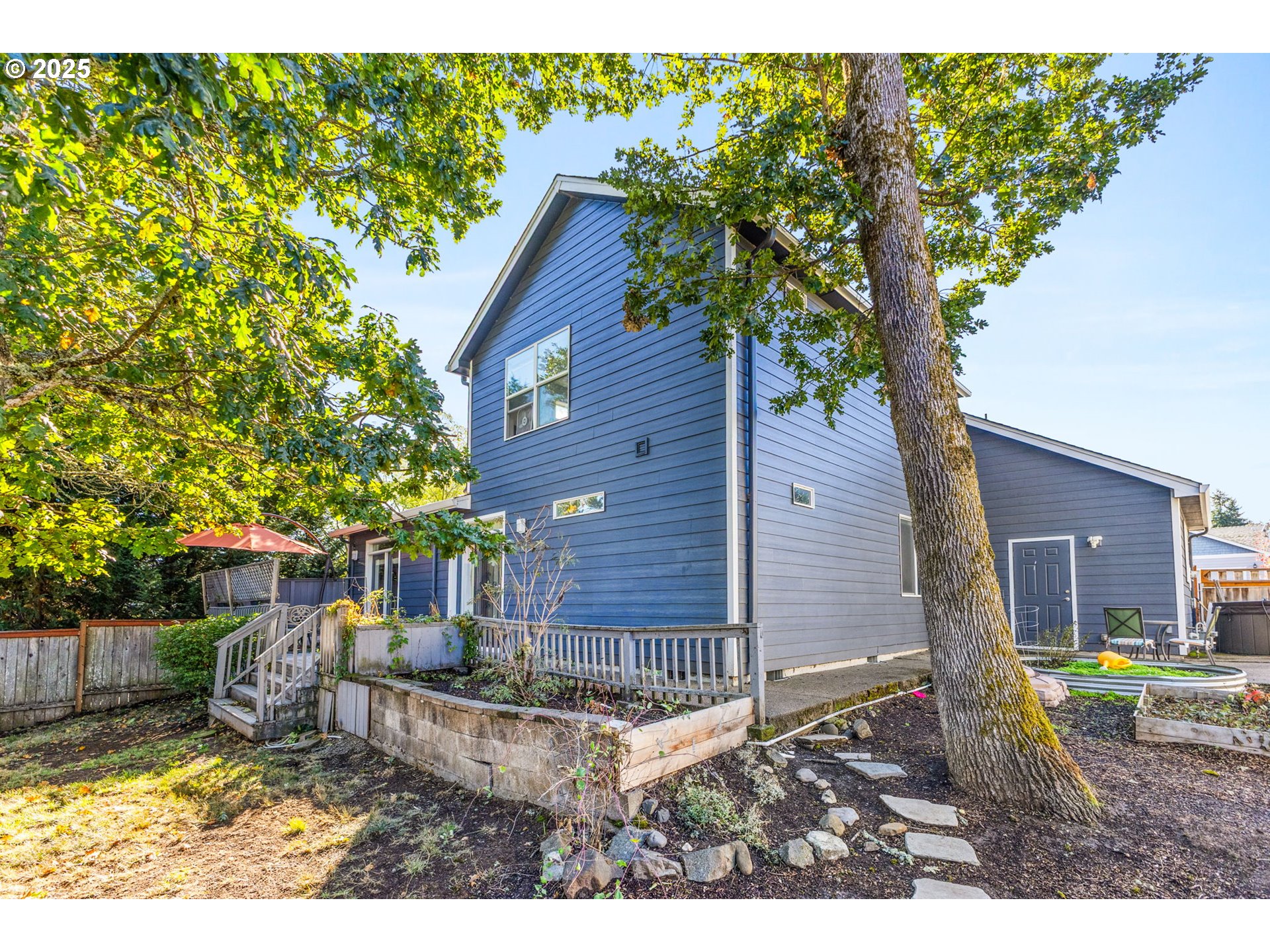 610 Northwest Hillcrest Drive Dallas, OR 97338 - Photo 25 of 32 a backyard of a house with table and chairs