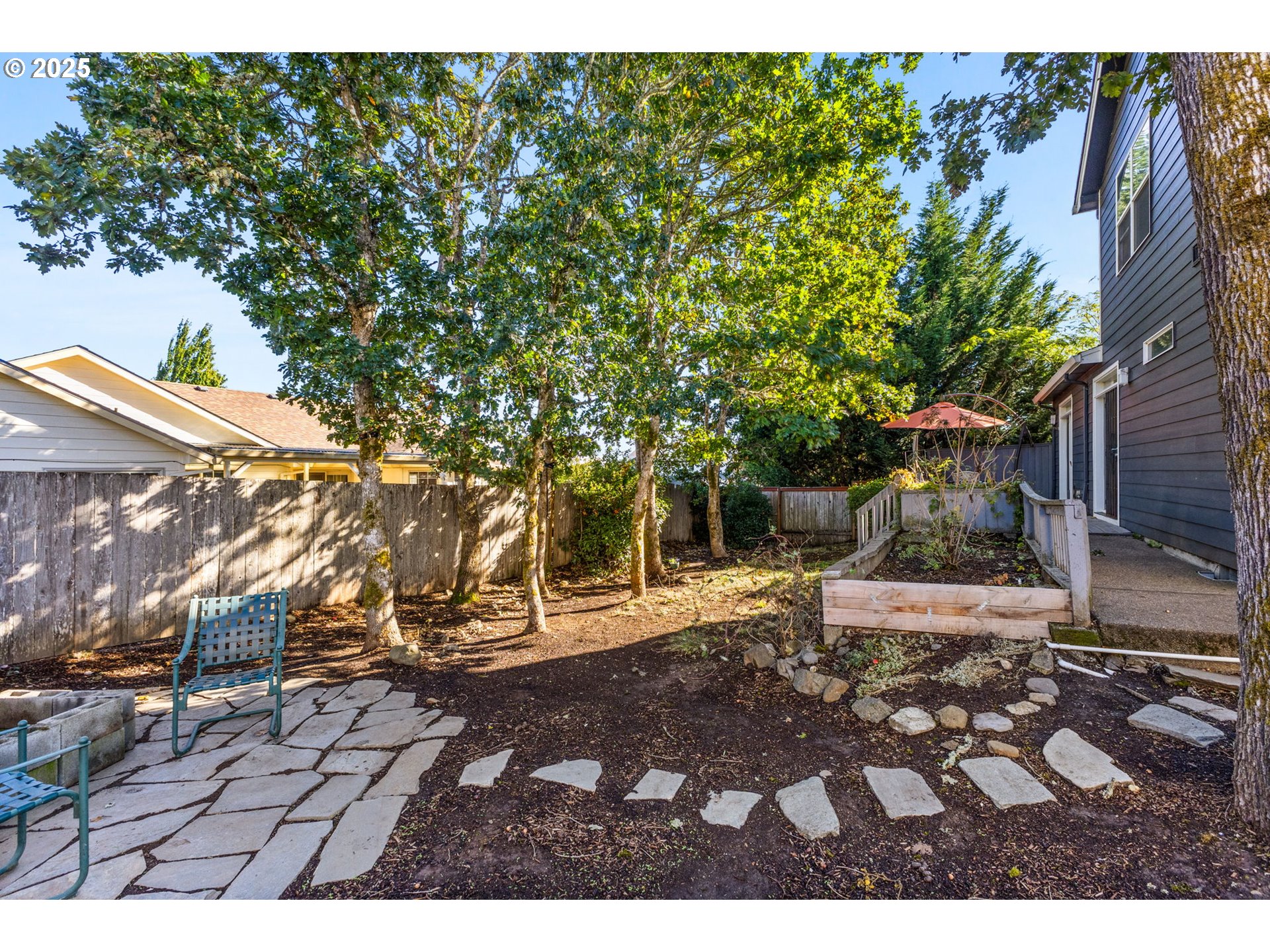 610 Northwest Hillcrest Drive Dallas, OR 97338 - Photo 26 of 32 a backyard of a house with table and chairs