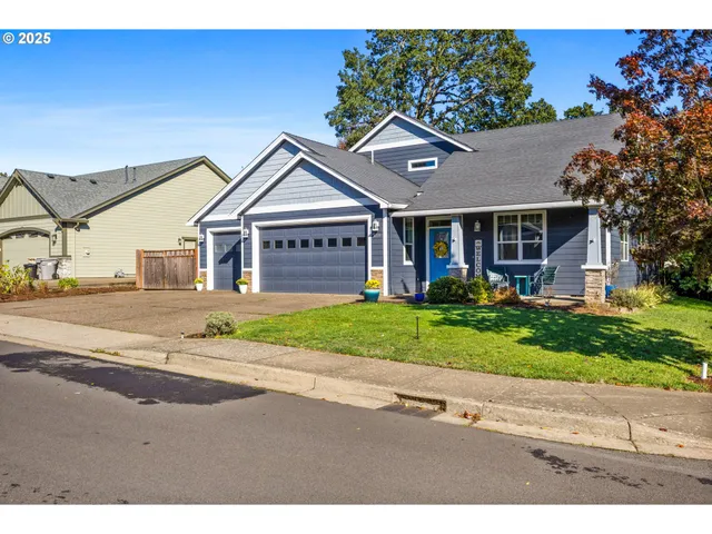 a front view of a house with a yard and outdoor seating