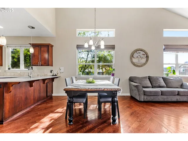 a living room with furniture a window and a dining table