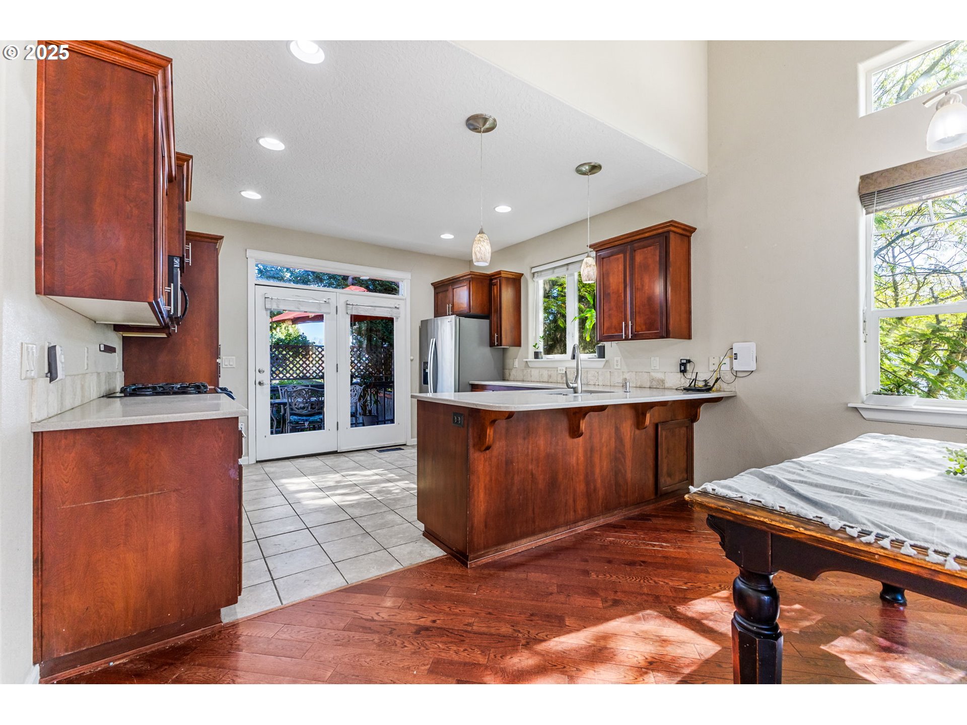 610 Northwest Hillcrest Drive Dallas, OR 97338 - Photo 8 of 32 a kitchen with stainless steel appliances kitchen island granite countertop wooden cabinets a sink a stove a dining table and chairs