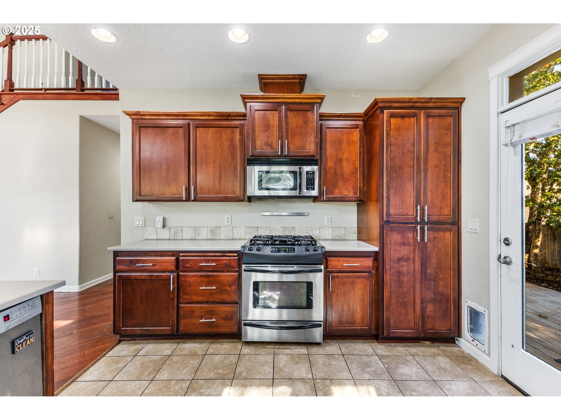 610 Northwest Hillcrest Drive Dallas, OR 97338 - Photo 10 of 32 a kitchen with stainless steel appliances granite countertop a stove and a refrigerator