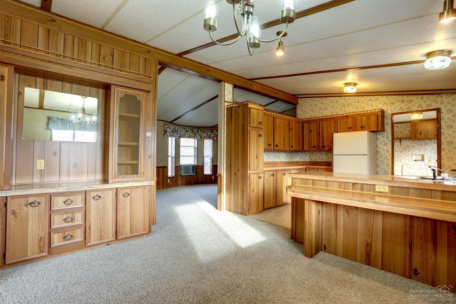 65040 Hunnell Road Bend, OR 97703 - Photo 12 of 25 a large kitchen with cabinets a sink and stainless steel appliances