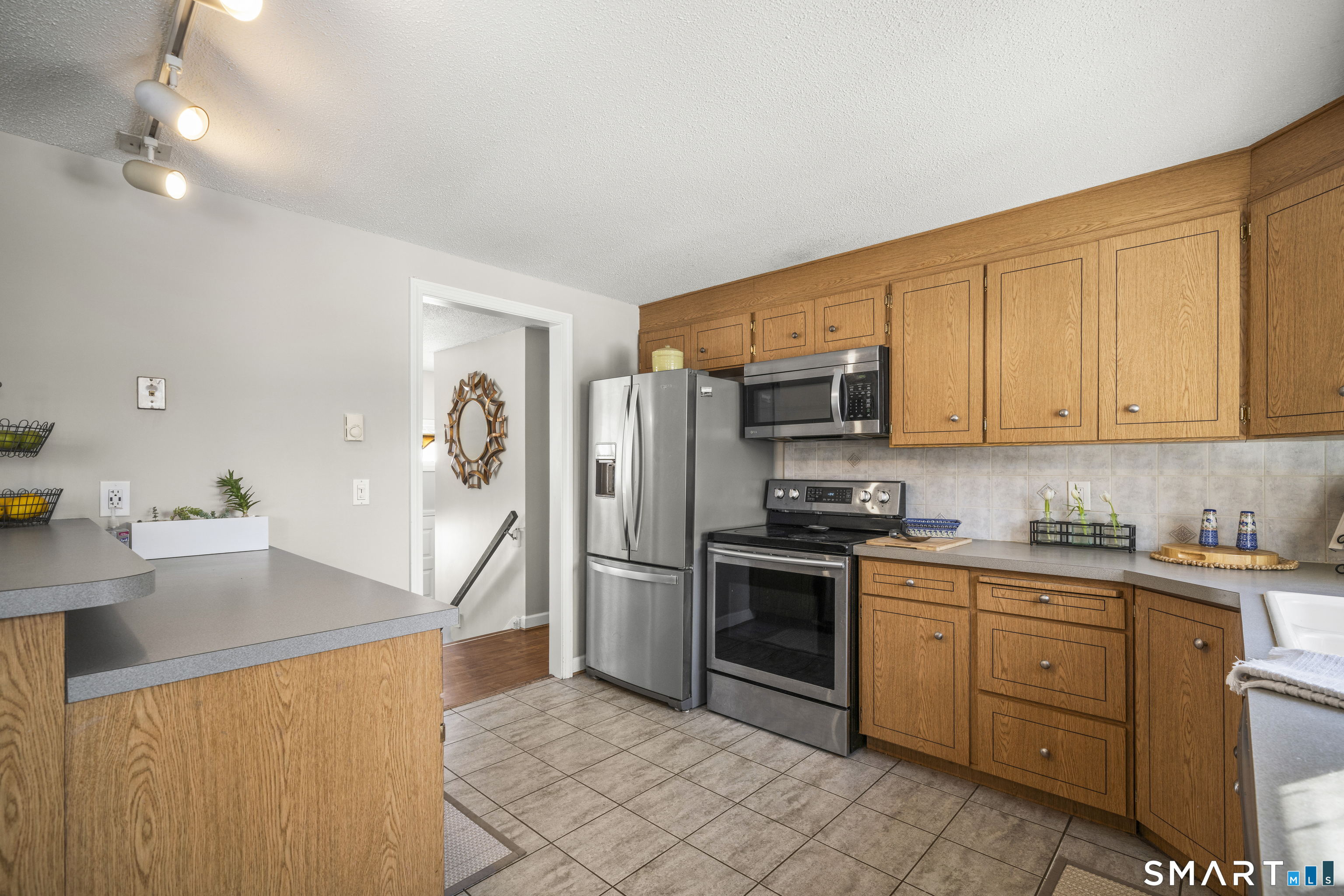 51 Barrett Road Enfield, CT 06082 - Photo 13 of 35 a kitchen with stainless steel appliances granite countertop a sink stove and refrigerator