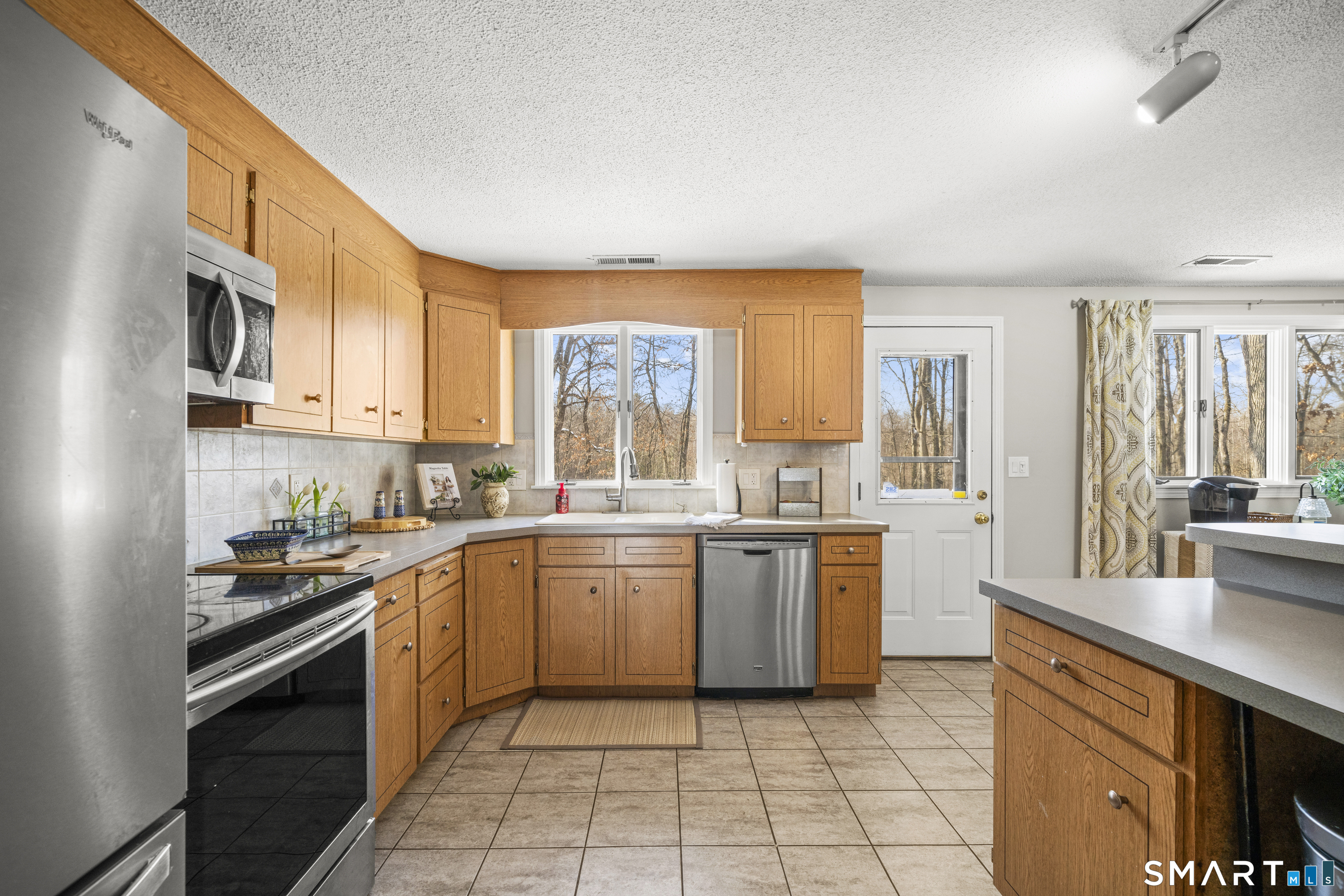 51 Barrett Road Enfield, CT 06082 - Photo 14 of 35 a kitchen with a sink stove top oven and cabinets