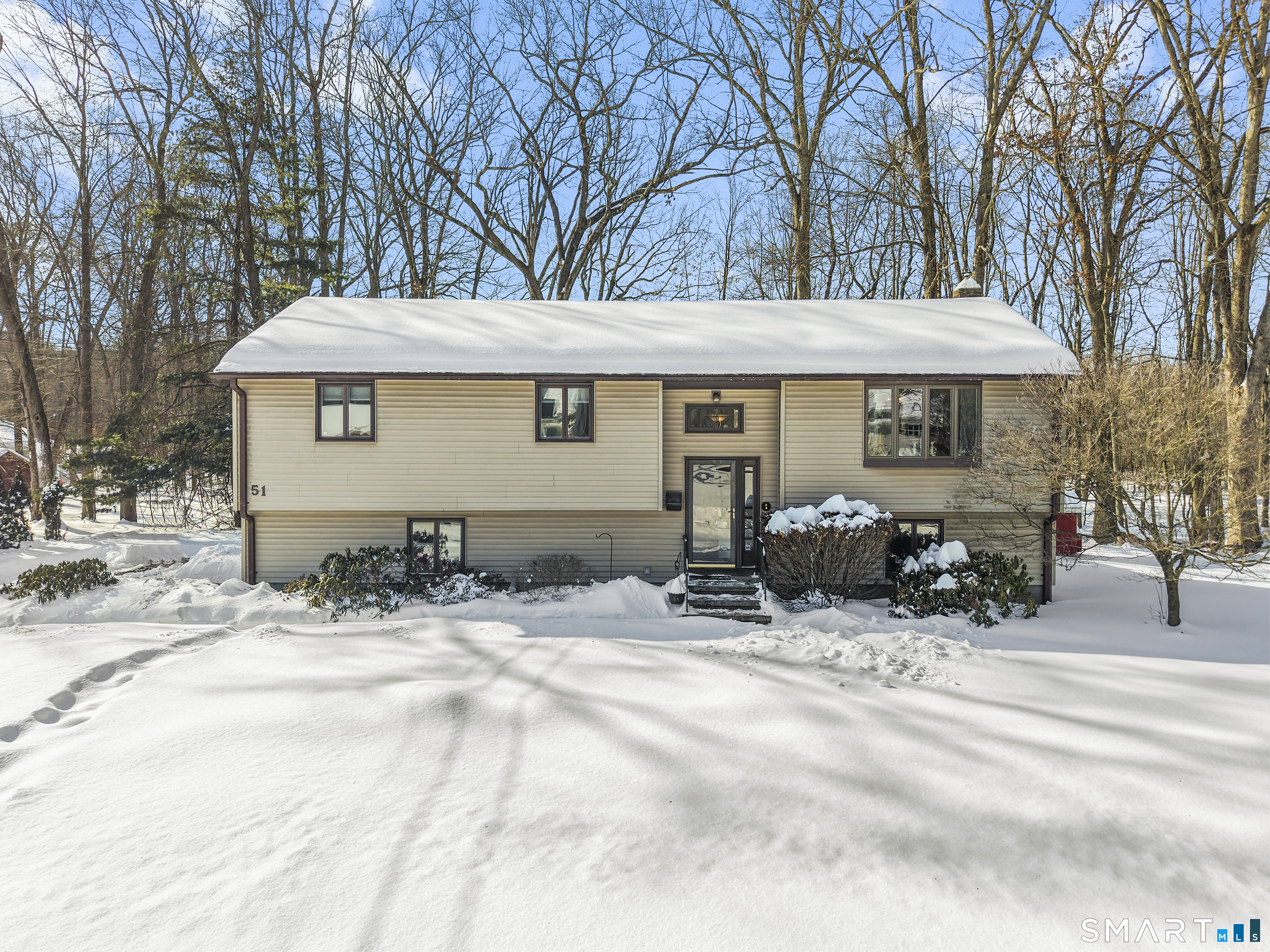 51 Barrett Road Enfield, CT 06082 - Photo 5 of 35 a view of a house with a yard covered with snow in front of house