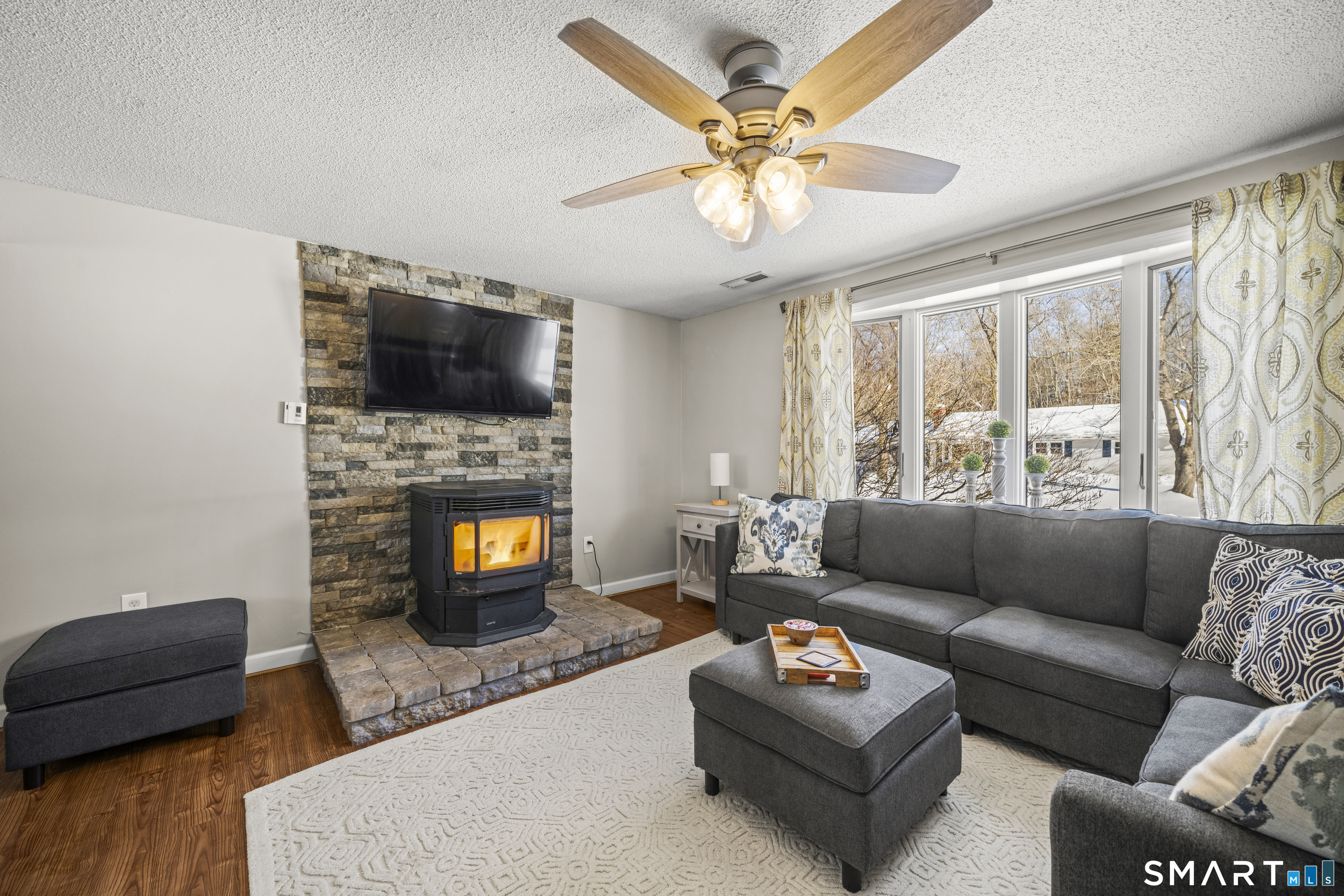 51 Barrett Road Enfield, CT 06082 - Photo 7 of 35 a living room with furniture a flat screen tv and a fireplace