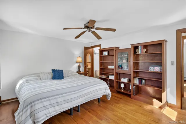 a bedroom with a bed a chandelier and closet
