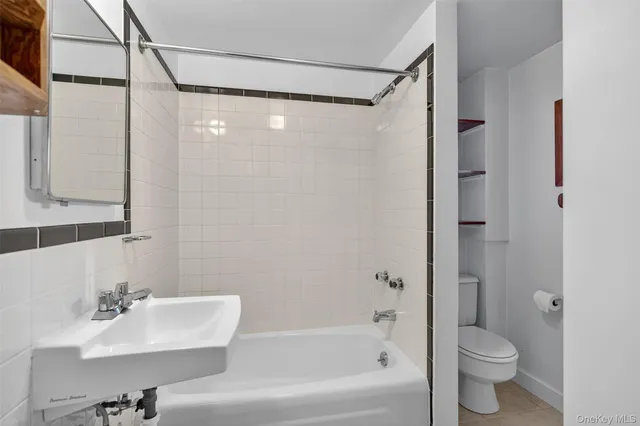 a bathroom with a bathtub shower sink and toilet