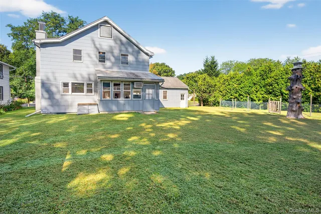 a large house with a big yard and large trees