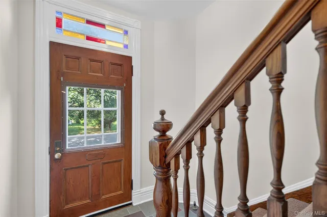 a view of an entryway with wooden floor