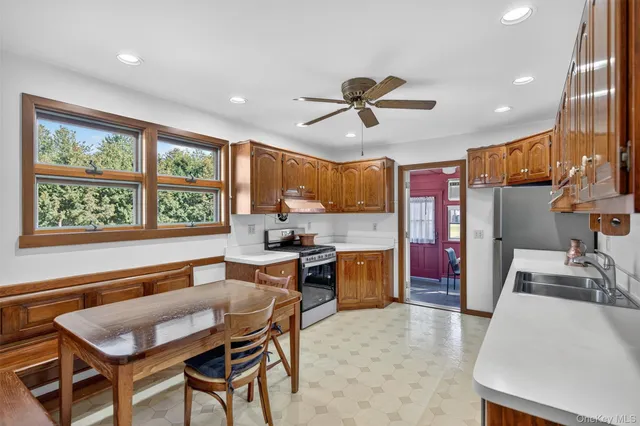 a large kitchen with a table and chairs in it