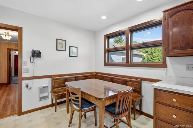 a view of a dining room with furniture and a window
