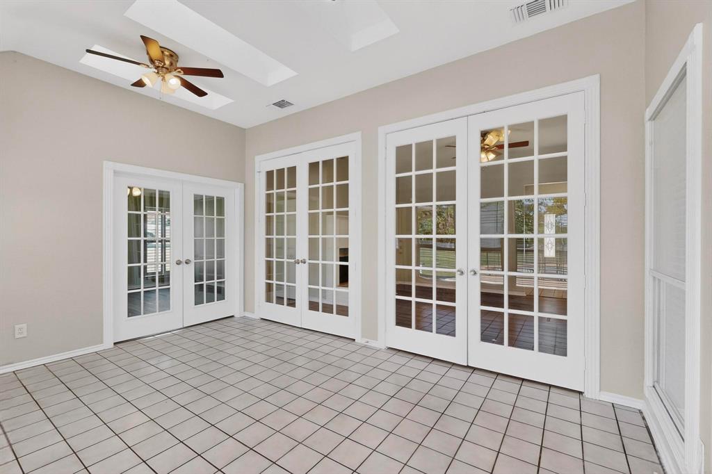 2601 Trail Tree Court Burleson, TX 76028 - Photo 13 of 40 Unfurnished sunroom with french doors, a skylight, and tile patterned flooring