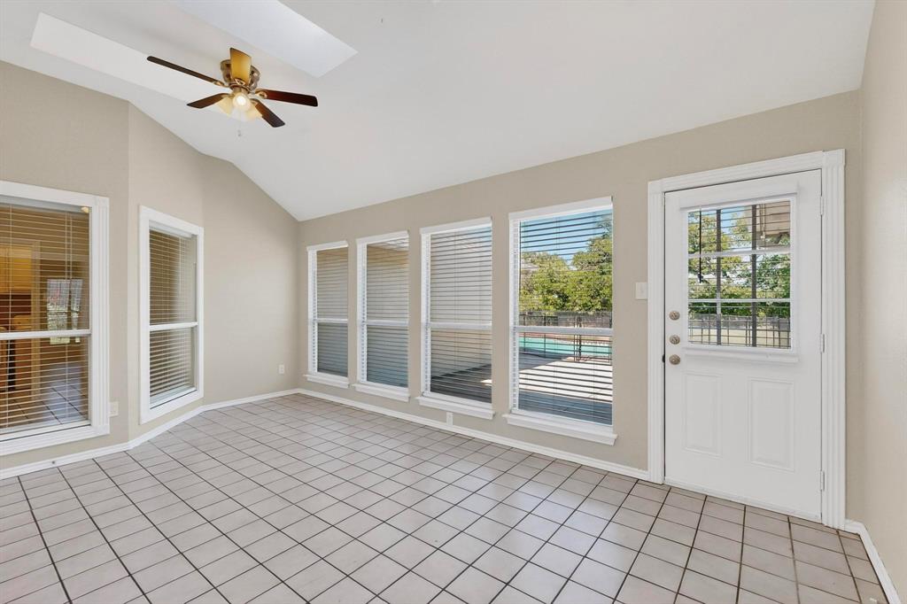 2601 Trail Tree Court Burleson, TX 76028 - Photo 14 of 40 Unfurnished sunroom with a skylight, tile patterned flooring, and vaulted ceiling