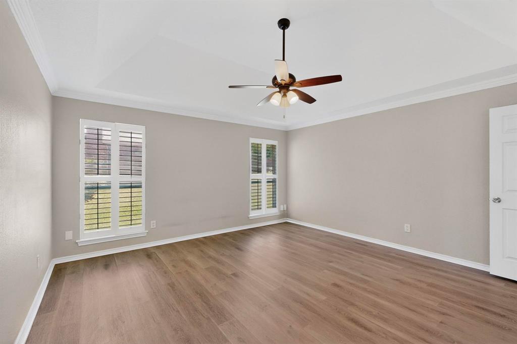 2601 Trail Tree Court Burleson, TX 76028 - Photo 20 of 40 Unfurnished room with crown molding, dark wood-style floors, and a ceiling fan