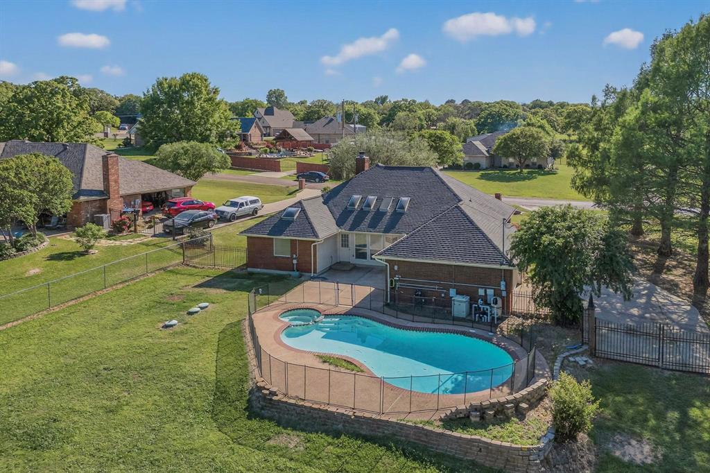2601 Trail Tree Court Burleson, TX 76028 - Photo 2 of 40 Relaxing pool / spa featuring a patio area, a fenced backyard, and view of wooded area