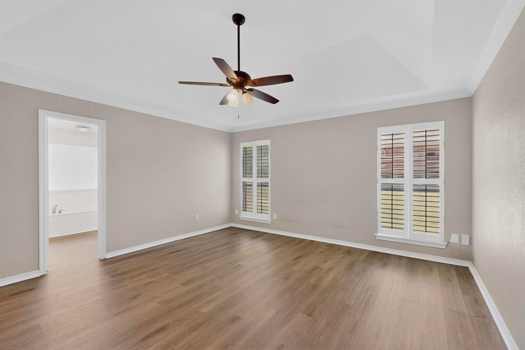 2601 Trail Tree Court Burleson, TX 76028 - Photo 21 of 40 Spare room with ornamental molding, ceiling fan, and dark wood-style floors