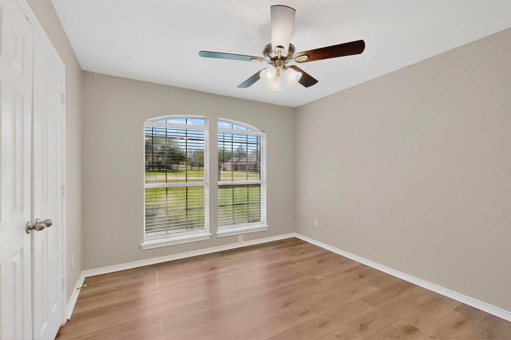 2601 Trail Tree Court Burleson, TX 76028 - Photo 26 of 40 Unfurnished room with light wood finished floors and a ceiling fan