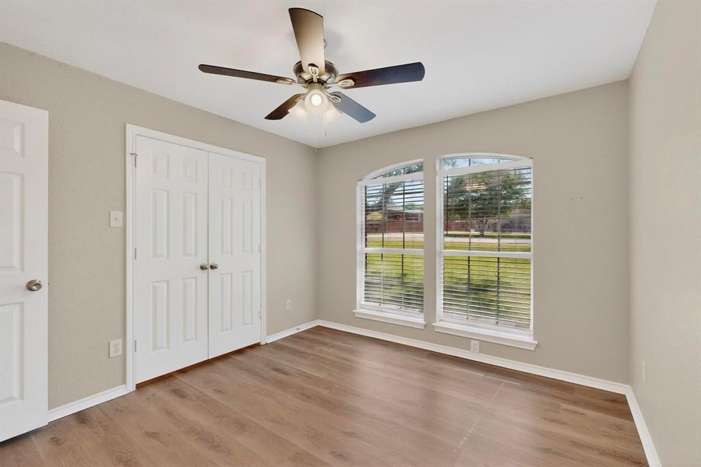 2601 Trail Tree Court Burleson, TX 76028 - Photo 27 of 40 Unfurnished bedroom featuring light wood-type flooring, a ceiling fan, and a closet