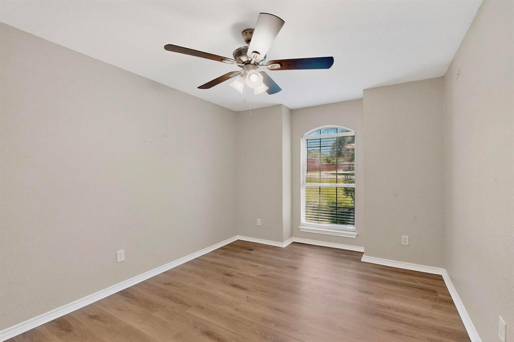 2601 Trail Tree Court Burleson, TX 76028 - Photo 28 of 40 Unfurnished room featuring wood finished floors and a ceiling fan