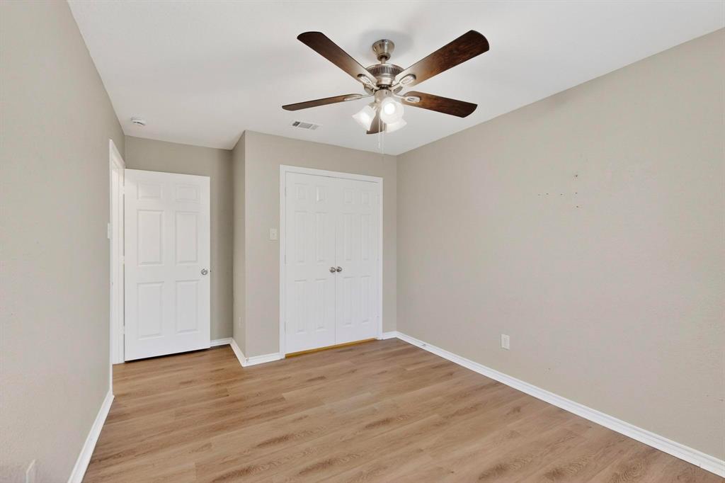 2601 Trail Tree Court Burleson, TX 76028 - Photo 29 of 40 Unfurnished bedroom with light wood-style flooring, a closet, and ceiling fan