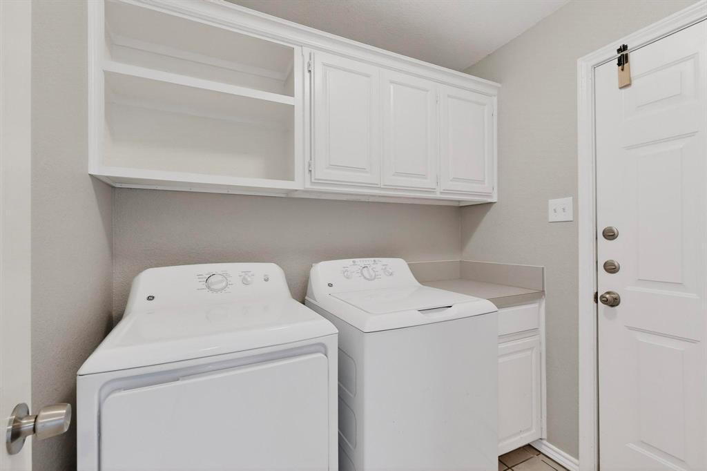 2601 Trail Tree Court Burleson, TX 76028 - Photo 33 of 40 Laundry area featuring washer and dryer and cabinet space