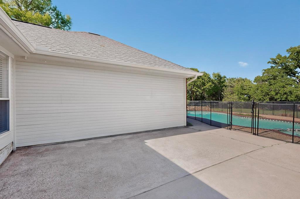 2601 Trail Tree Court Burleson, TX 76028 - Photo 34 of 40 Patio with access to garage and overlooks pool.