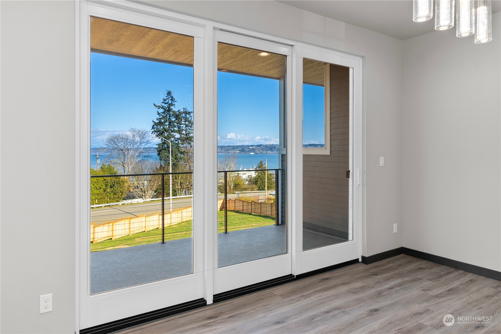 6441 Humphrey Road, Unit 4 Clinton, WA 98236 - Photo 18 of 40 an empty room with wooden floor and door