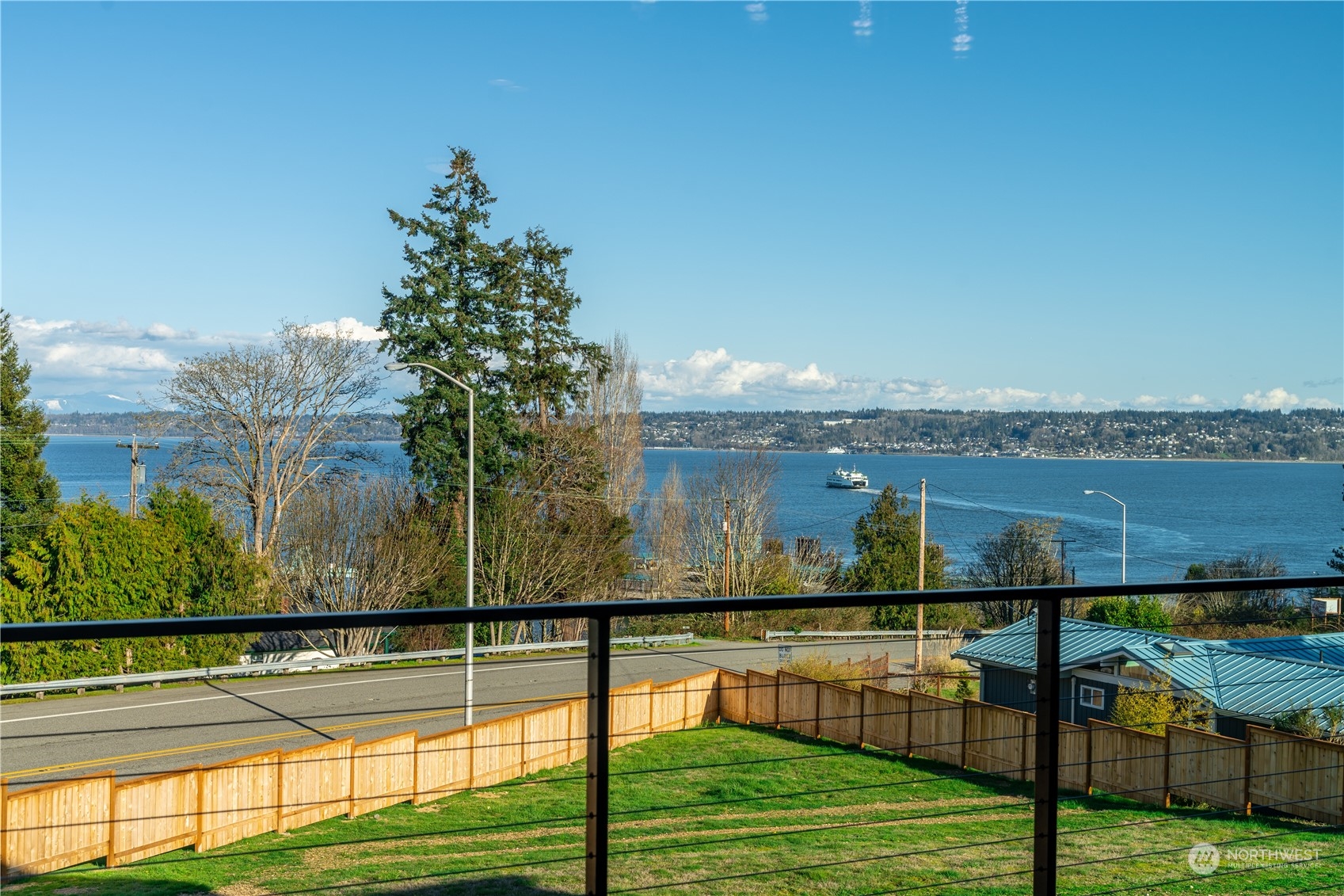 6441 Humphrey Road, Unit 4 Clinton, WA 98236 - Photo 19 of 40 a view of a balcony with floor to ceiling windows