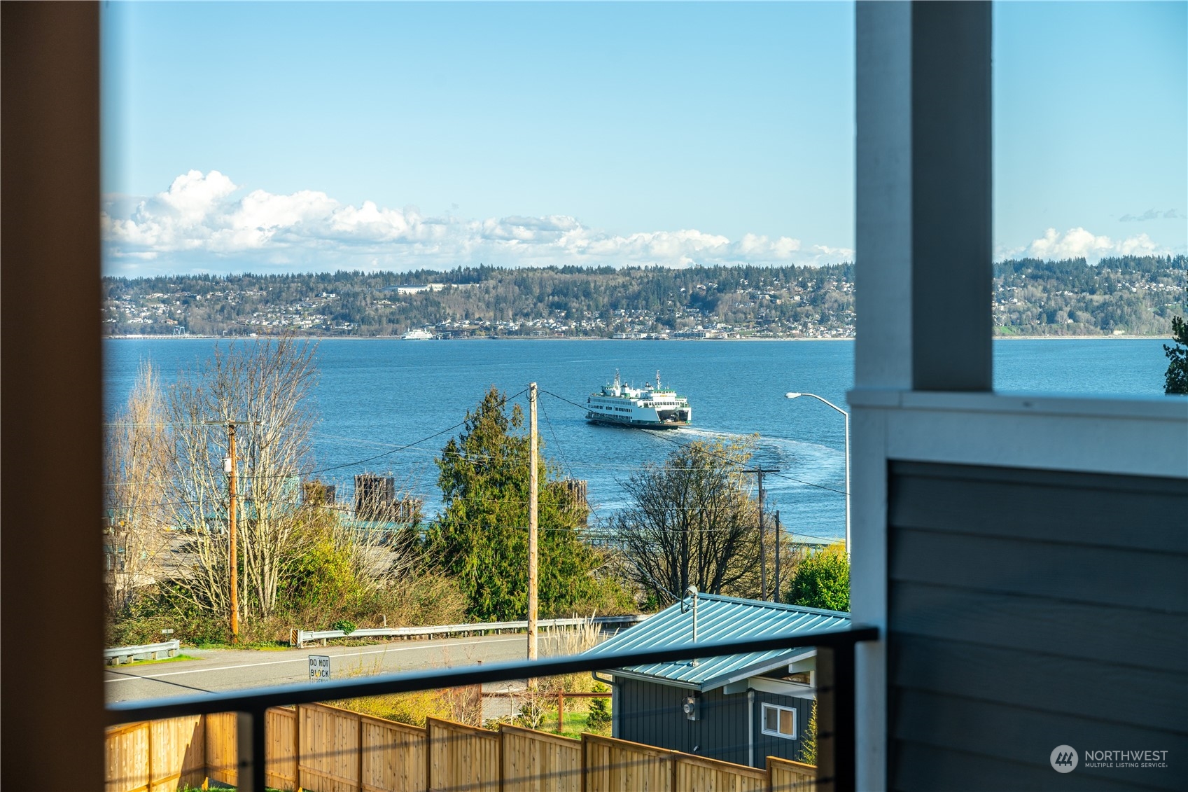 6441 Humphrey Road, Unit 4 Clinton, WA 98236 - Photo 2 of 40 a view of a lake from a balcony
