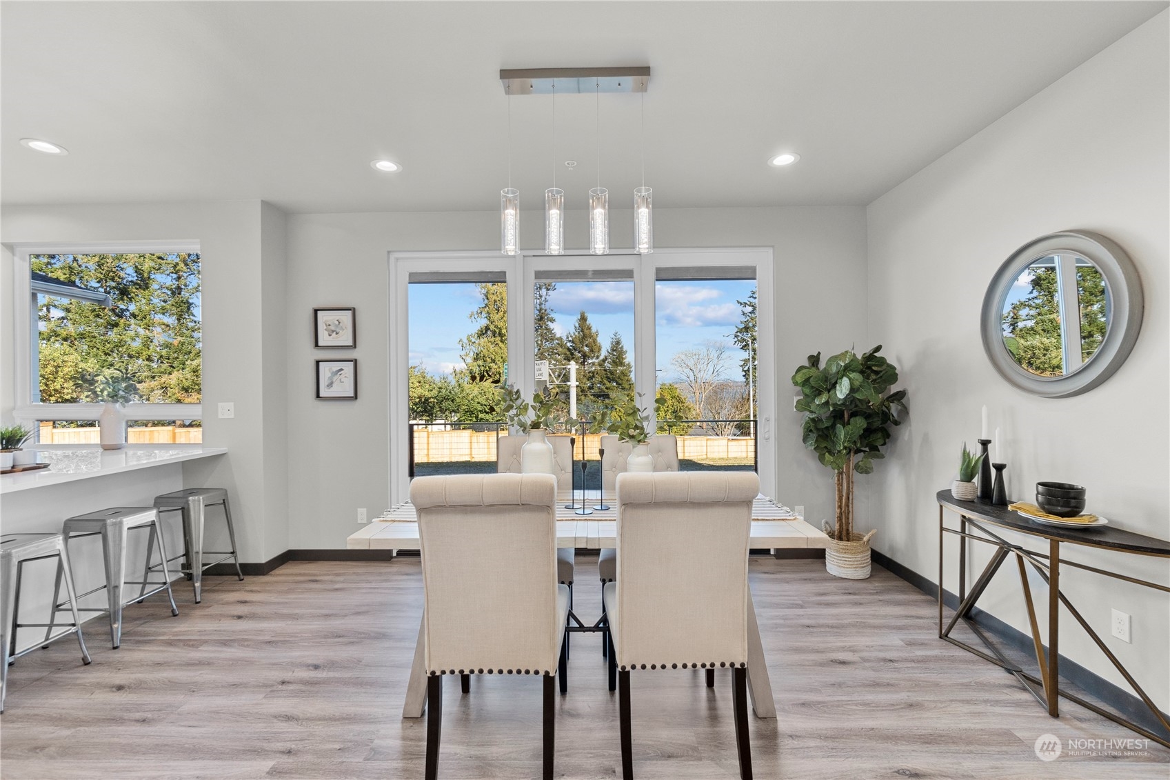 6441 Humphrey Road, Unit 4 Clinton, WA 98236 - Photo 9 of 40 a view of a dining room with furniture window and wooden floor