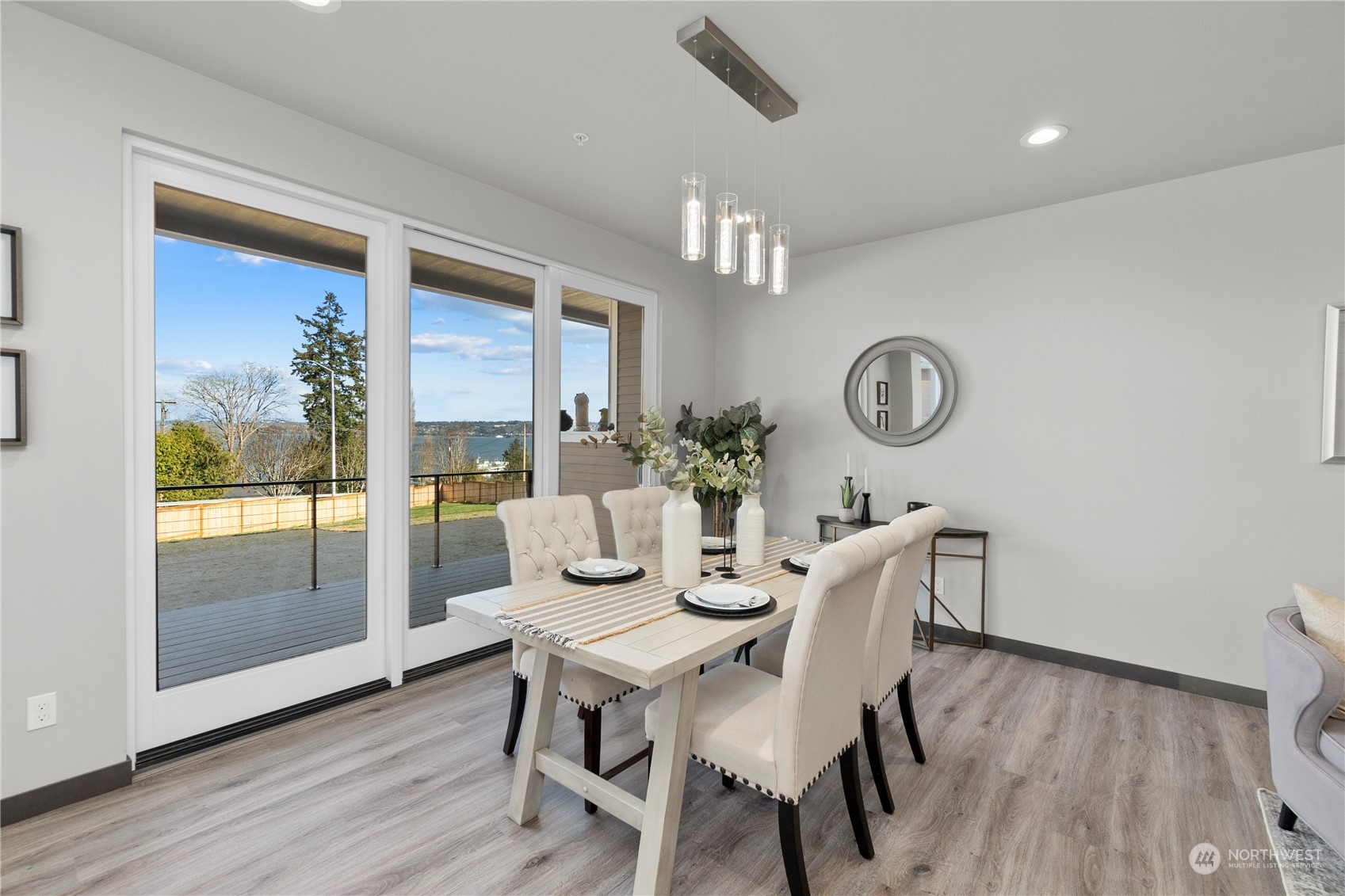 6441 Humphrey Road, Unit 4 Clinton, WA 98236 - Photo 10 of 40 a view of a dining room with furniture window and wooden floor