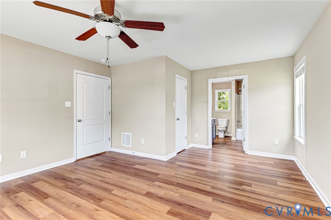 9925 Reymet Court Richmond, VA 23237 - Photo 15 of 30 a view of a room with wooden floor and a ceiling fan