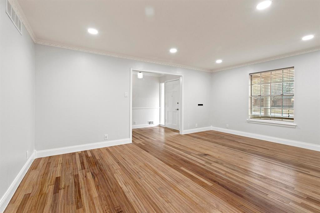 527 East Spring Valley Road Richardson, TX 75081 - Photo 7 of 19 a view of empty room with wooden floor and fan