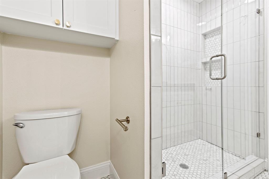 527 East Spring Valley Road Richardson, TX 75081 - Photo 9 of 19 a white toilet sitting next to a bathroom