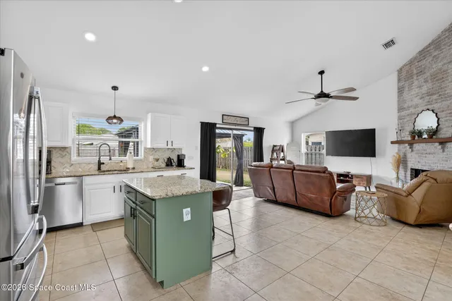 a kitchen with stainless steel appliances a refrigerator sink and cabinets