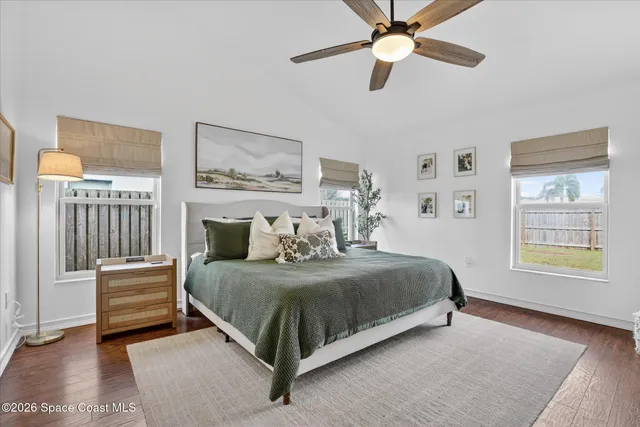 a bedroom with furniture and a flat screen tv