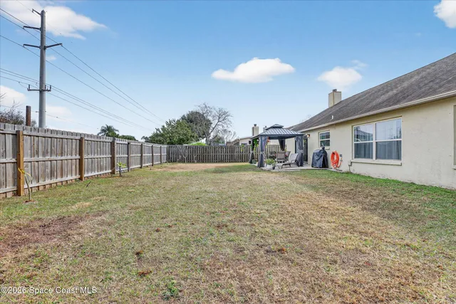 a view of outdoor dining space with a table and chairs