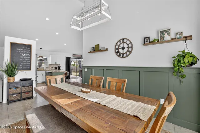 a kitchen that has a lot of cabinets and refrigerator in it