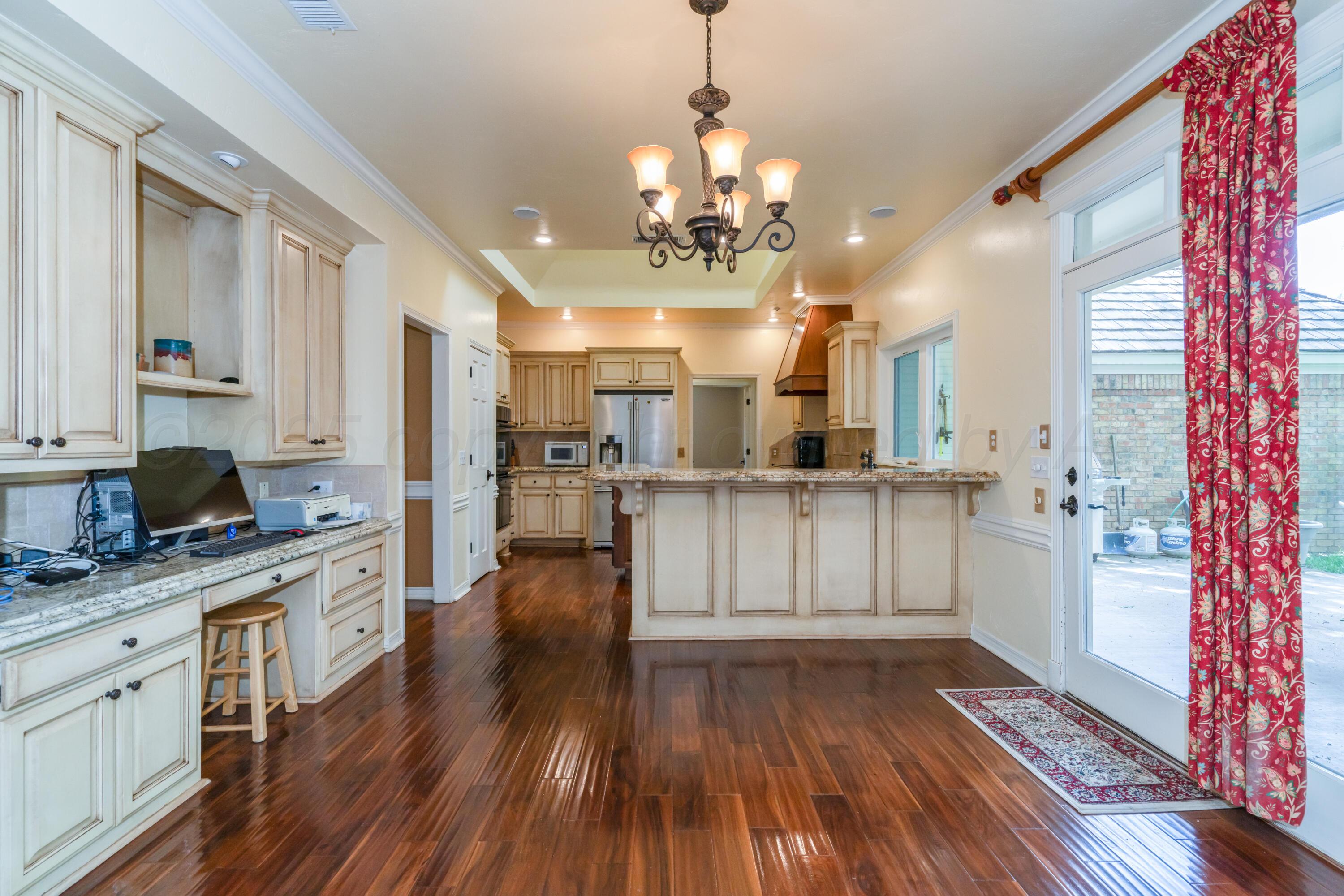 3501 Van Winkle Drive Amarillo, TX 79121 - Photo 16 of 35 a large white kitchen with cabinets and wooden floor