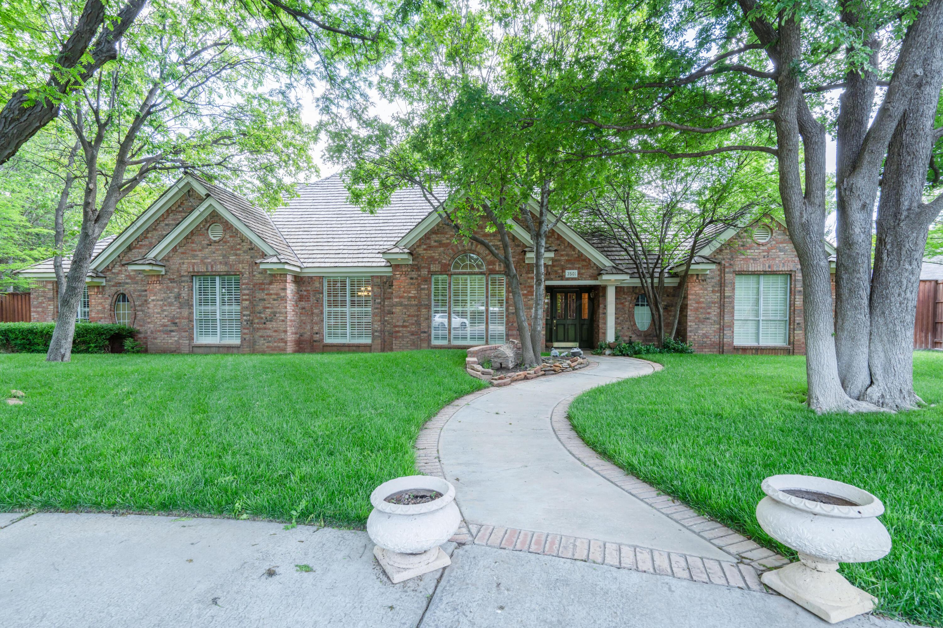 3501 Van Winkle Drive Amarillo, TX 79121 - Photo 2 of 35 a front view of a house with a yard and trees
