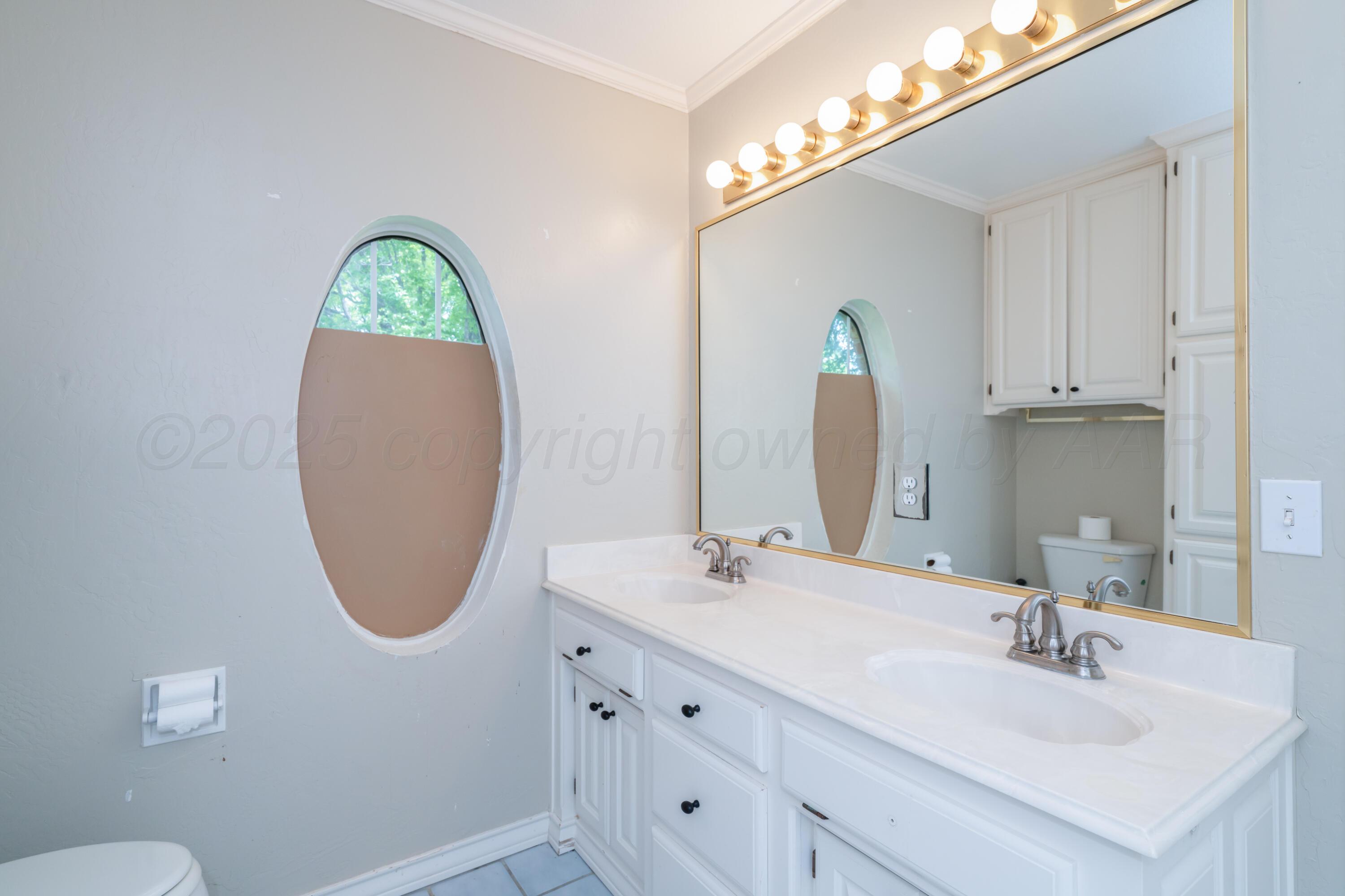 3501 Van Winkle Drive Amarillo, TX 79121 - Photo 26 of 35 a bathroom with a sink and a mirror