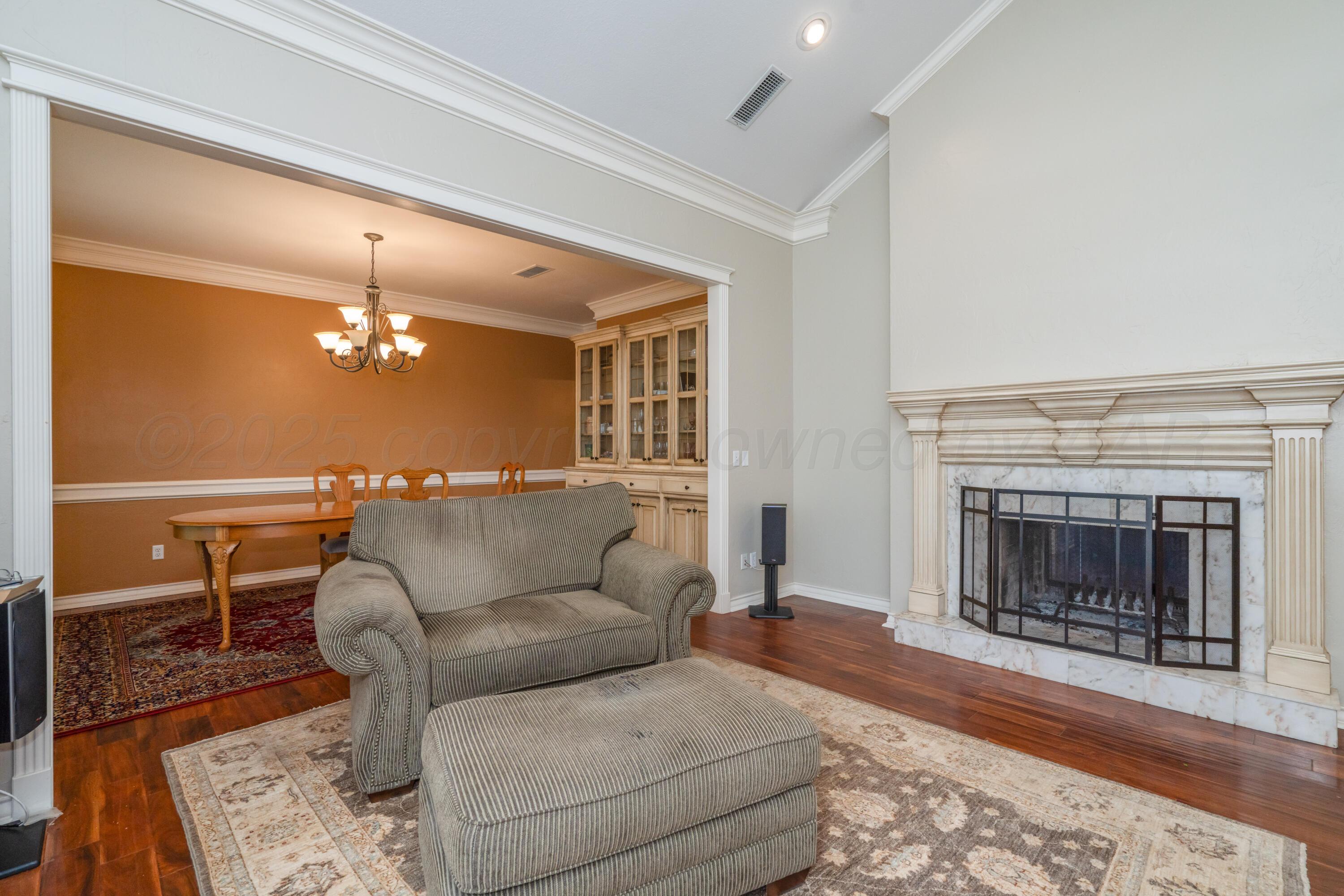 3501 Van Winkle Drive Amarillo, TX 79121 - Photo 4 of 35 a living room with furniture a fireplace and a table