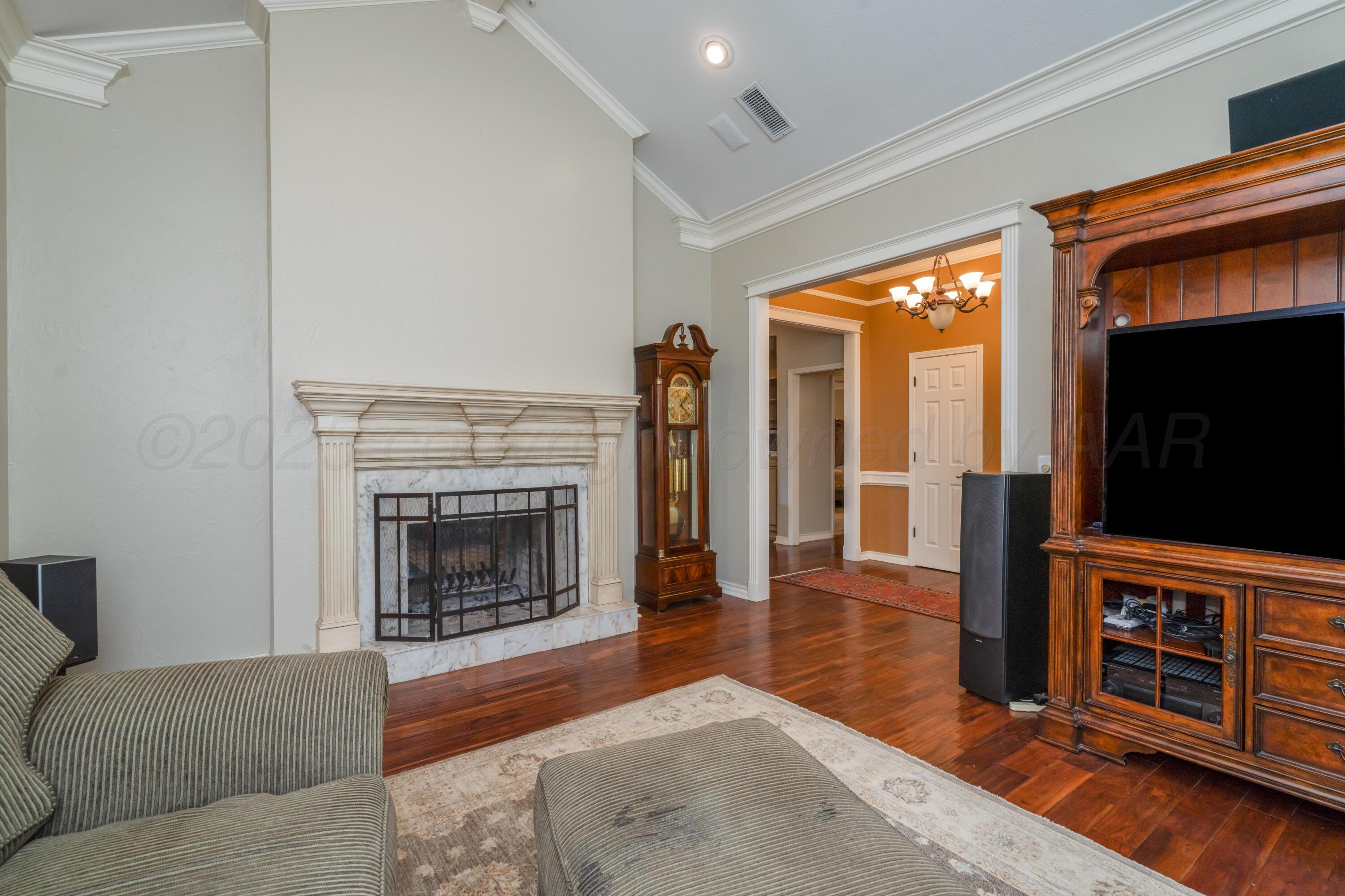 3501 Van Winkle Drive Amarillo, TX 79121 - Photo 5 of 35 a living room with furniture a fireplace and a flat screen tv